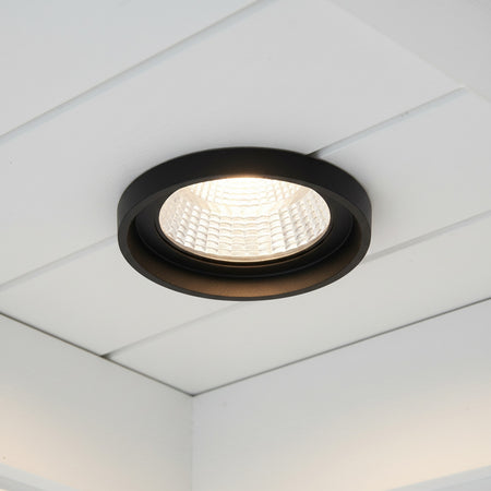 black exterior downlight mounted on the white ceiling on the exterior of a home