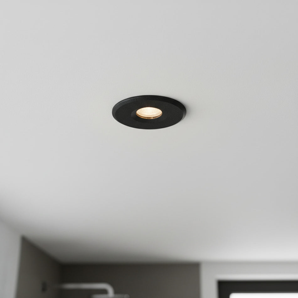 black waterproof recessed bathroom ceiling light installed in a modern bathroom