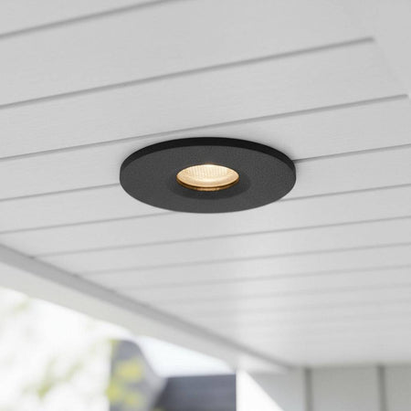 black small outdoor downlight mounted under the soffit of a modern home