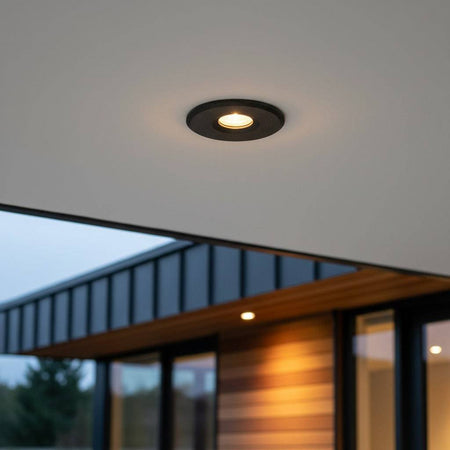 black small outdoor downlight mounted under the soffit of a modern home