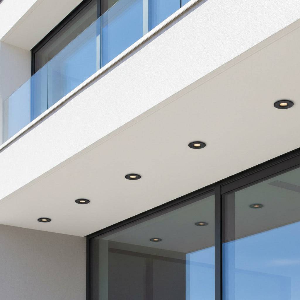 black small outdoor downlight mounted under roof of a modern home 