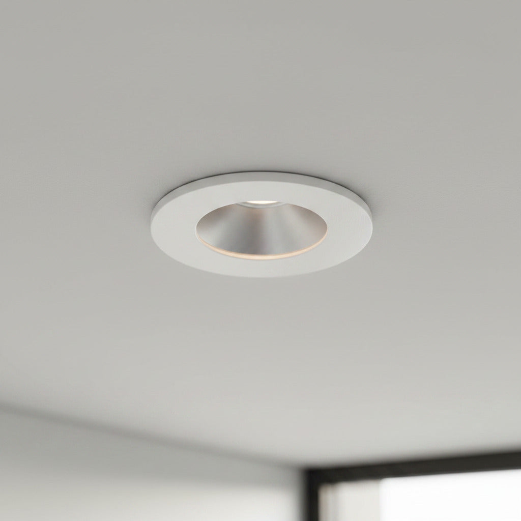 white recessed ceiling mounted downlight mounted on a grey ceiling 