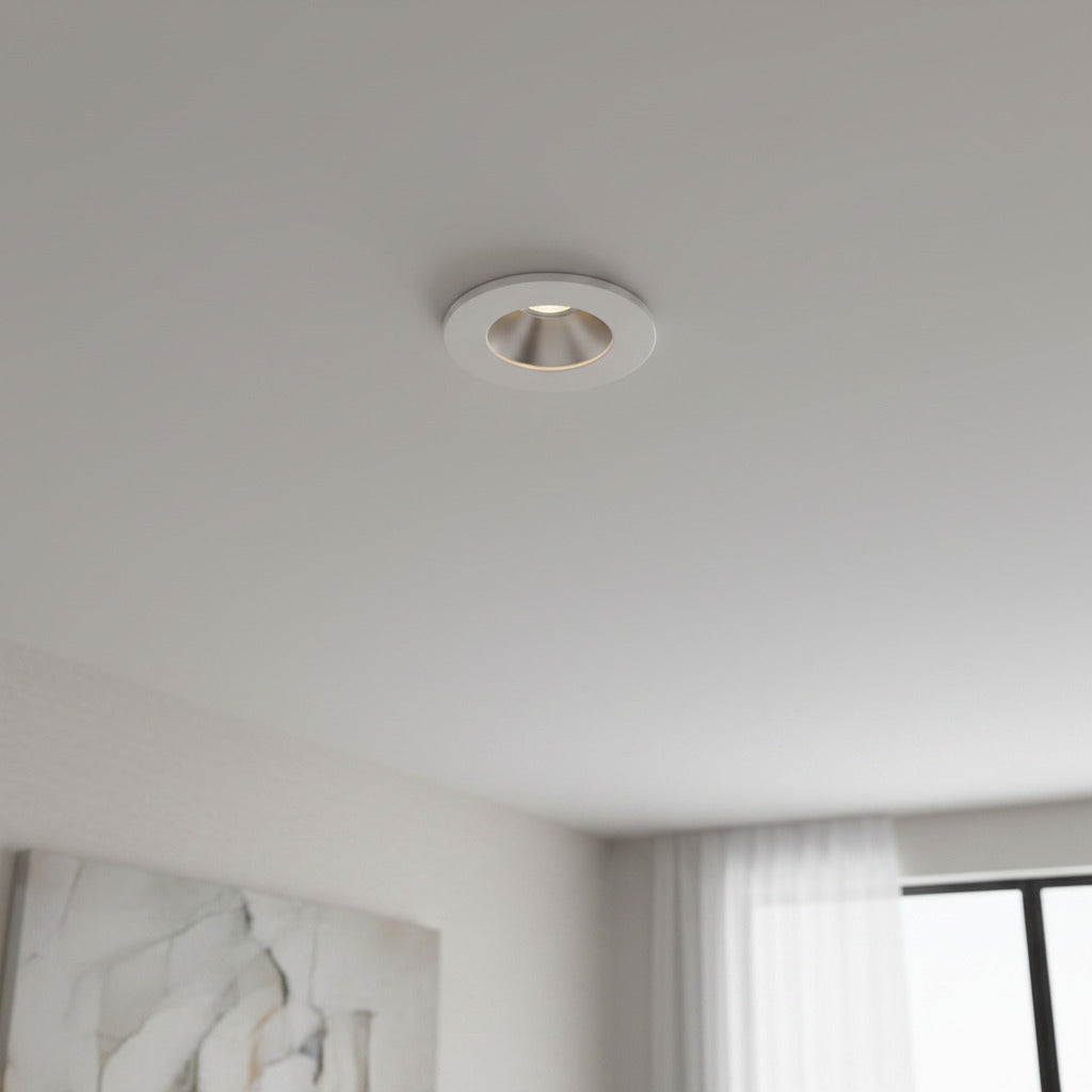 white recessed ceiling mounted downlight mounted on the ceiling in a modern home 