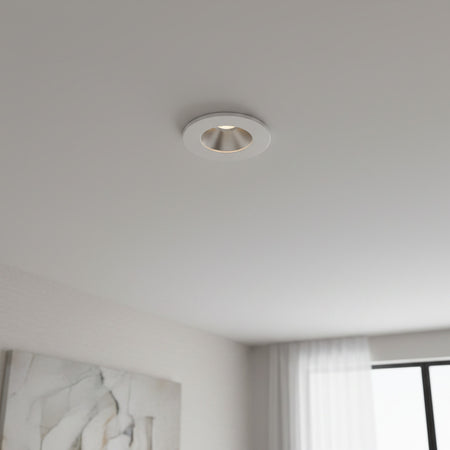 white recessed ceiling mounted downlight mounted on the ceiling in a modern home 