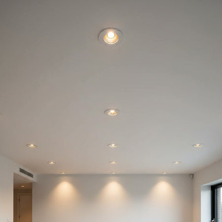 white recessed ceiling mounted downlight showing a number of lights mounted in the ceiling in a hotel room