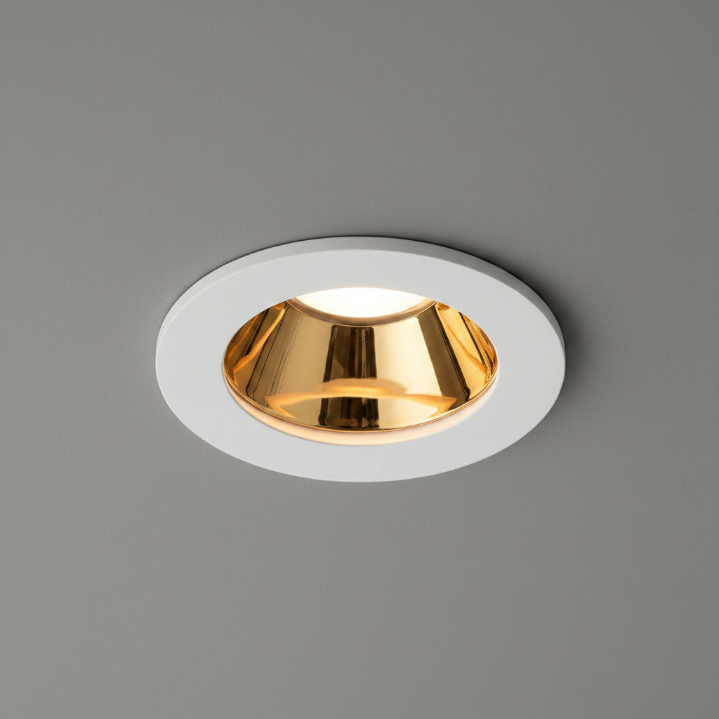white and gold downlight ceiling light fitted in a grey ceiling 