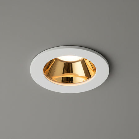 white and gold downlight ceiling light fitted in a grey ceiling 