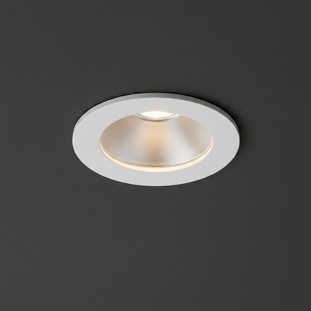 white recessed LED downlight fitting on a grey ceiling 