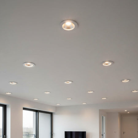 white recessed LED downlight fitting installed on the ceiling of a modern home