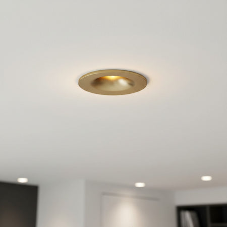 gold small ceiling spotlight recessed into the ceiling of a modern home
