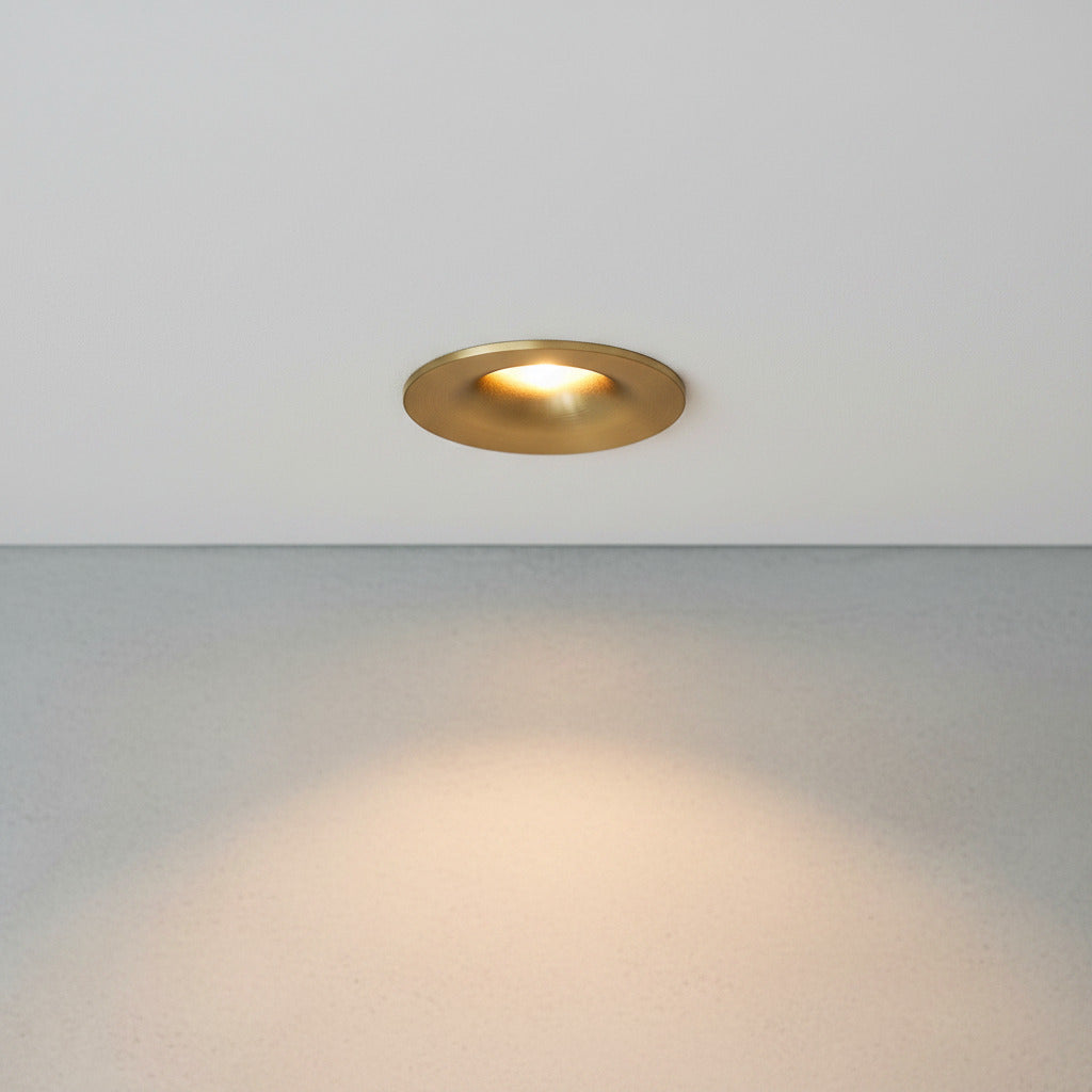gold small ceiling spotlight recessed into the ceiling in a modern home 