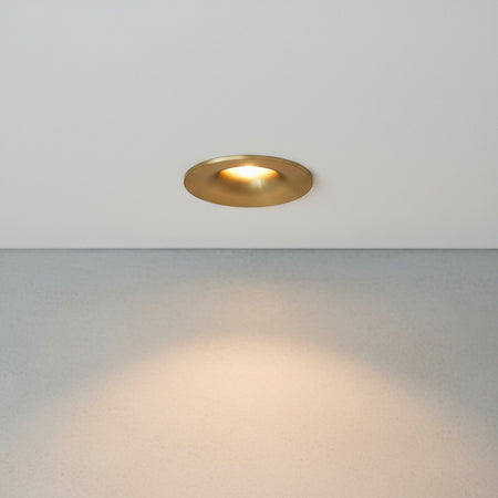 gold small ceiling spotlight recessed into the ceiling in a modern home 