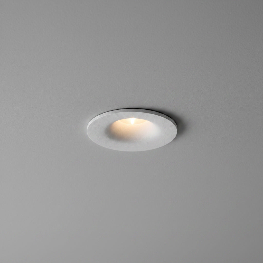 white small LED downlight fitting mounted in a grey ceiling 