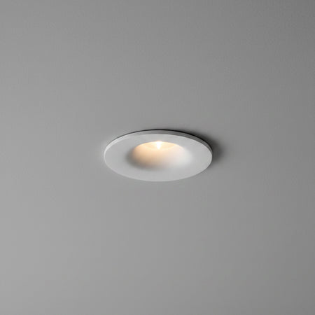 white small LED downlight fitting mounted in a grey ceiling 