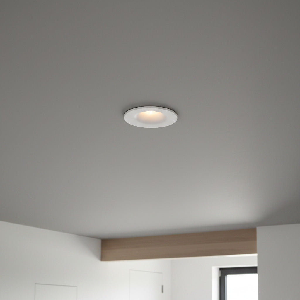 white small LED downlight fitting recessed into a grey ceiling in a modern home