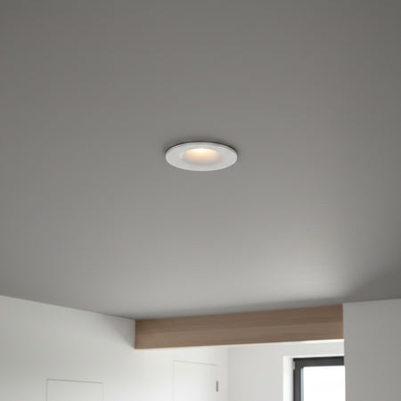 white small LED downlight fitting recessed into a grey ceiling in a modern home