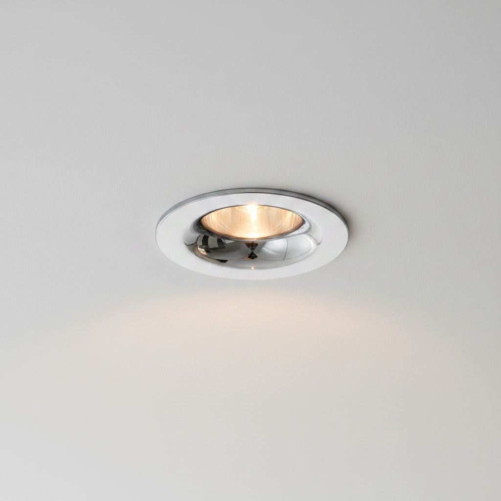 chrome LED recessed spot light installed on a light grey ceiling 