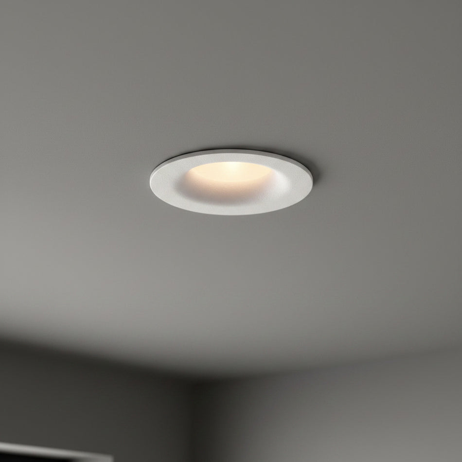white LED ceiling downlight mounted in a dark grey home ceiling 