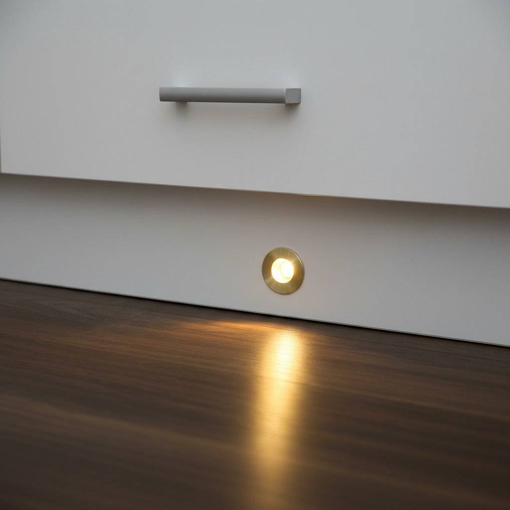 Gold kitchen plinth LED lights shown mounted into a white kitchen plinth. 