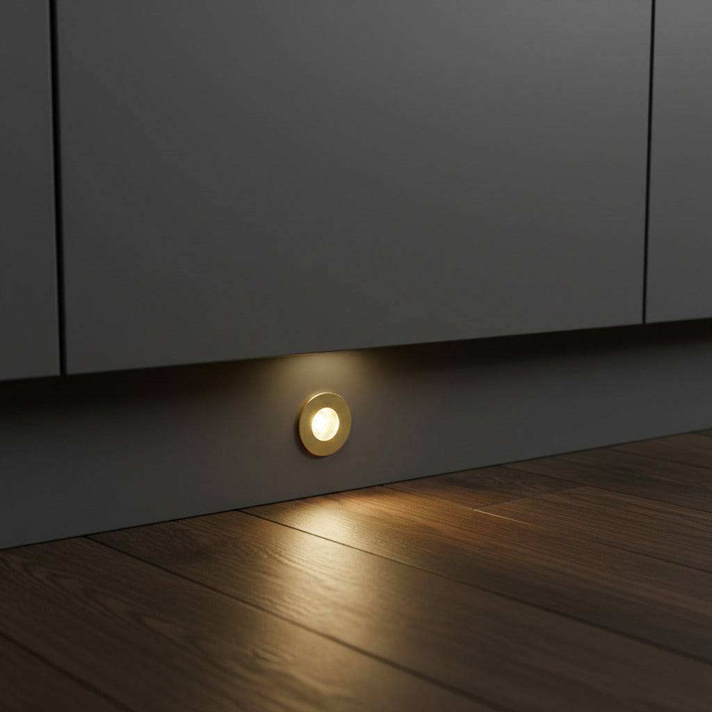 gold kitchen plinth light installed at low level in a grey kitchen kickboard