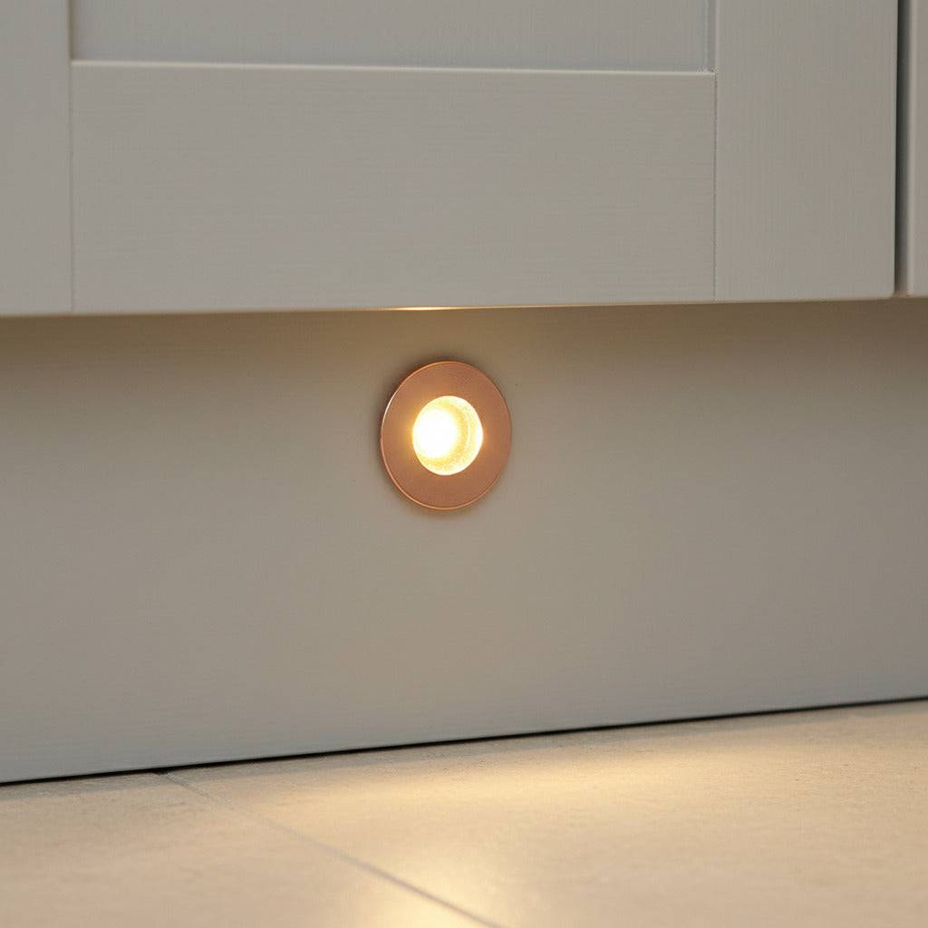 rose gold kitchen kickboard light installed in a white kitchen kickboard