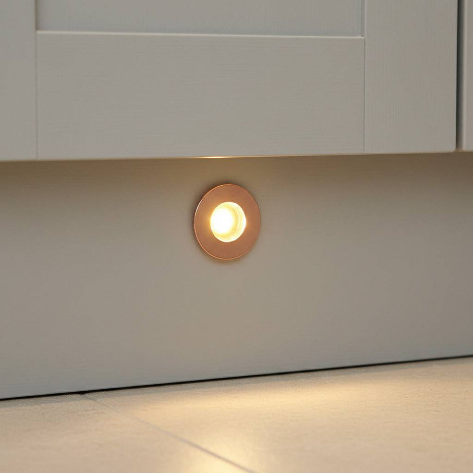 rose gold kitchen kickboard light installed in a white kitchen kickboard