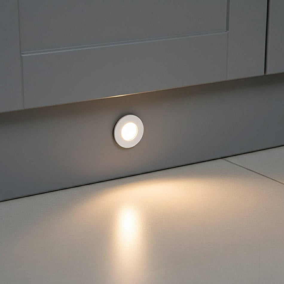 white LED plinth lights installed into the kickplate of a modern grey kitchen
