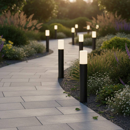 black bollard light shown with a number fitted alongside a winding pathway