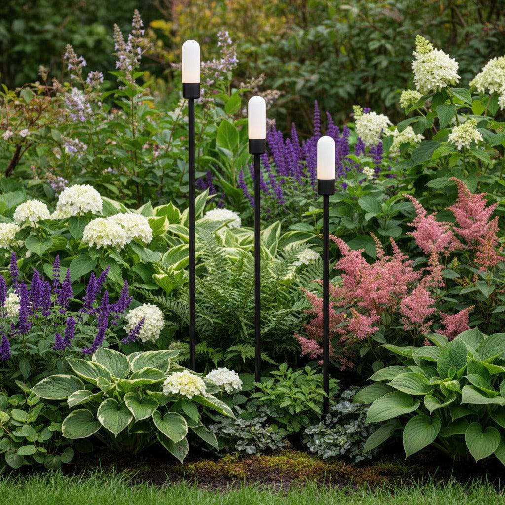 black garden spike light IP65 spiked into a garden border