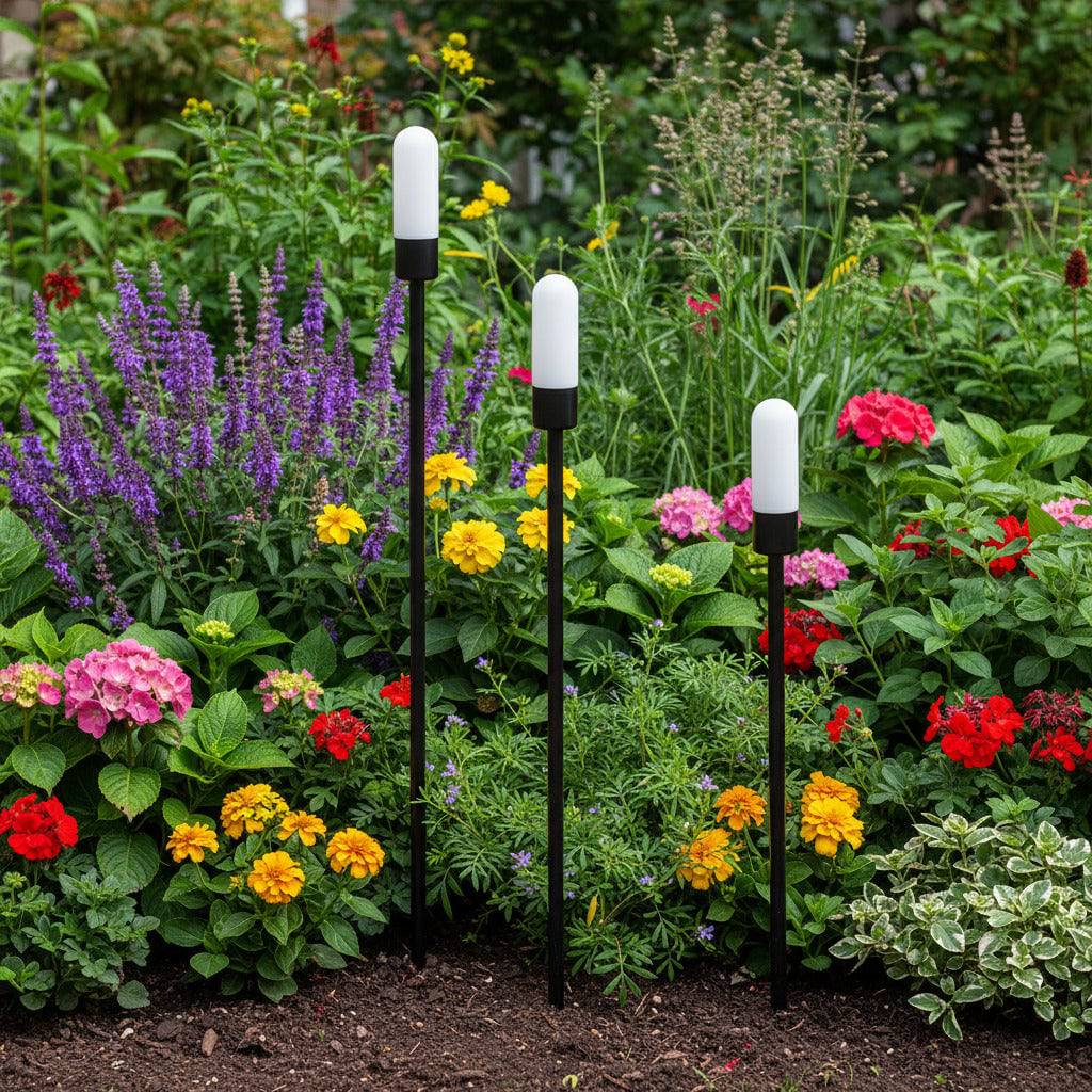 black garden spike light IP65 mounted at different heights in a garden border