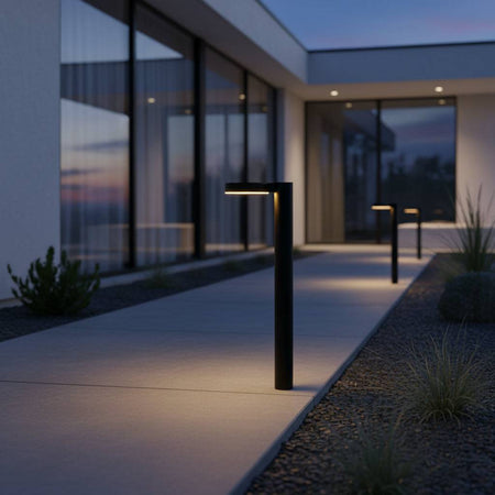 Black pathway bollard light  leading to entrance to a modern home