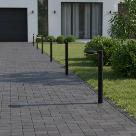 Black pathway bollard light on a driveway of a modern home