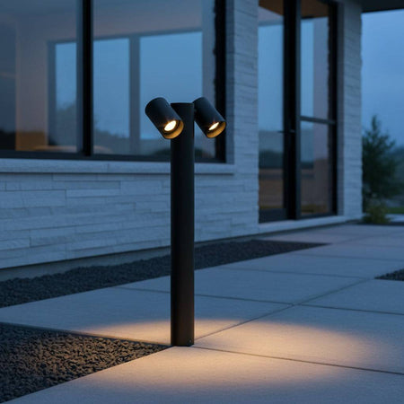 Black two spotlight bollard light  lighting a pathway to a modern home