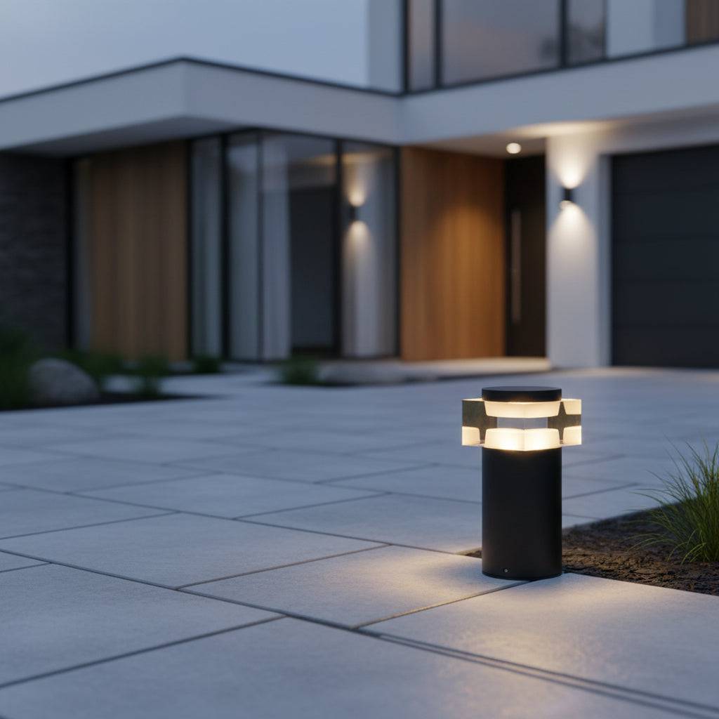 Black short bollard light on modern paved driveway