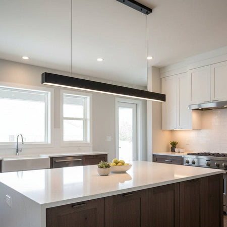 Black hanging bar light above a kitchen island in a modern home