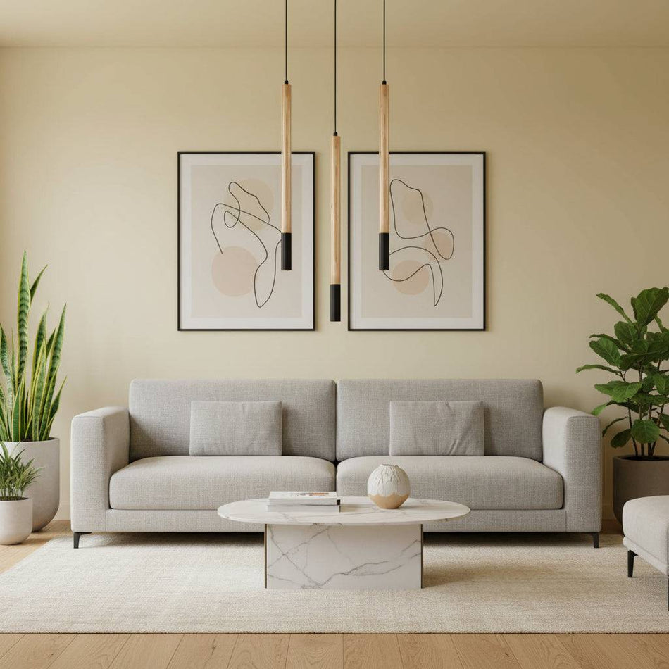 Wooden pendant light in a modern lounge three lights above a sofa with plants