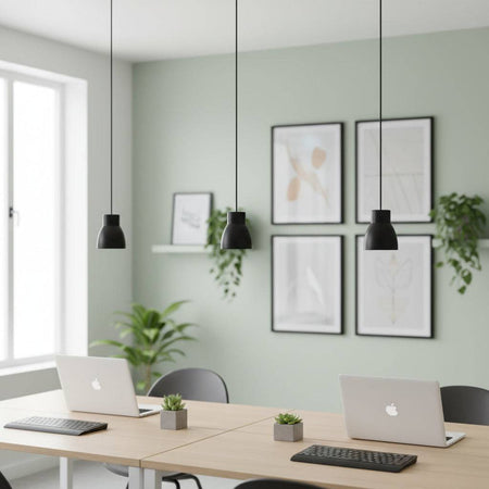 Black LED pendant light three above desks with laptops on them in a modern setting