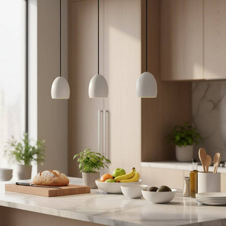 White modern hanging ceiling light in a kitchen above a worktop with kitchen utensils and fruit and plants
