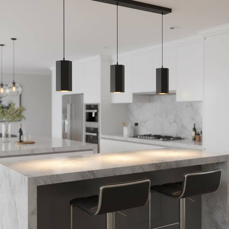 Black pendant light fitting above a breakfast bar in a modern home