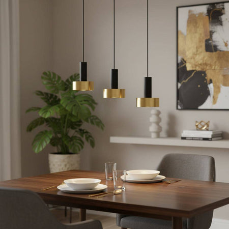 Black and gold pendant light fixture in a dining room above a table  three lights with a picture in the background