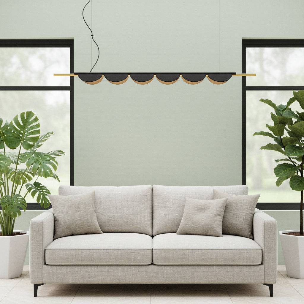 Linear pendant lamp in a modern conservatory above a sofa with plants either side