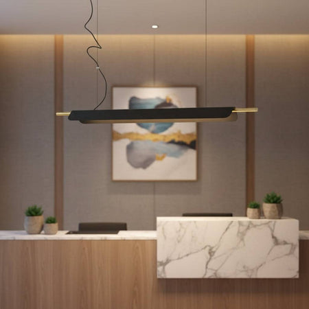 Linear suspension light above a hotel reception desk
