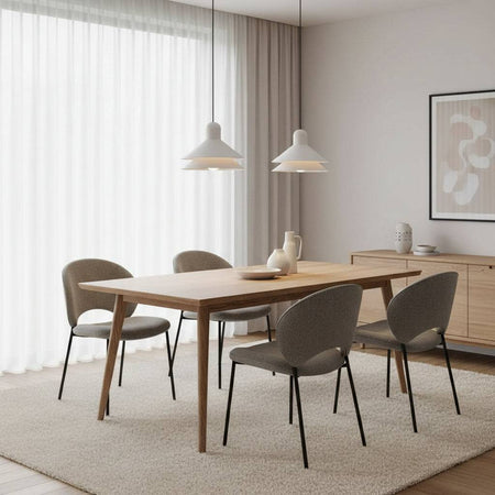 White ceiling pendant fitting two lights above a dining room table in a modern home