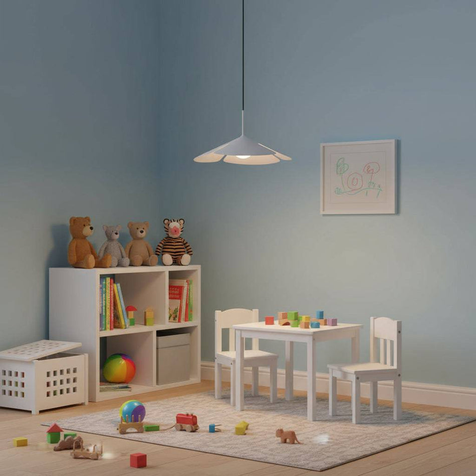 White pendant light fitting in a child's bedroom with toys over the floor and pale blue walls