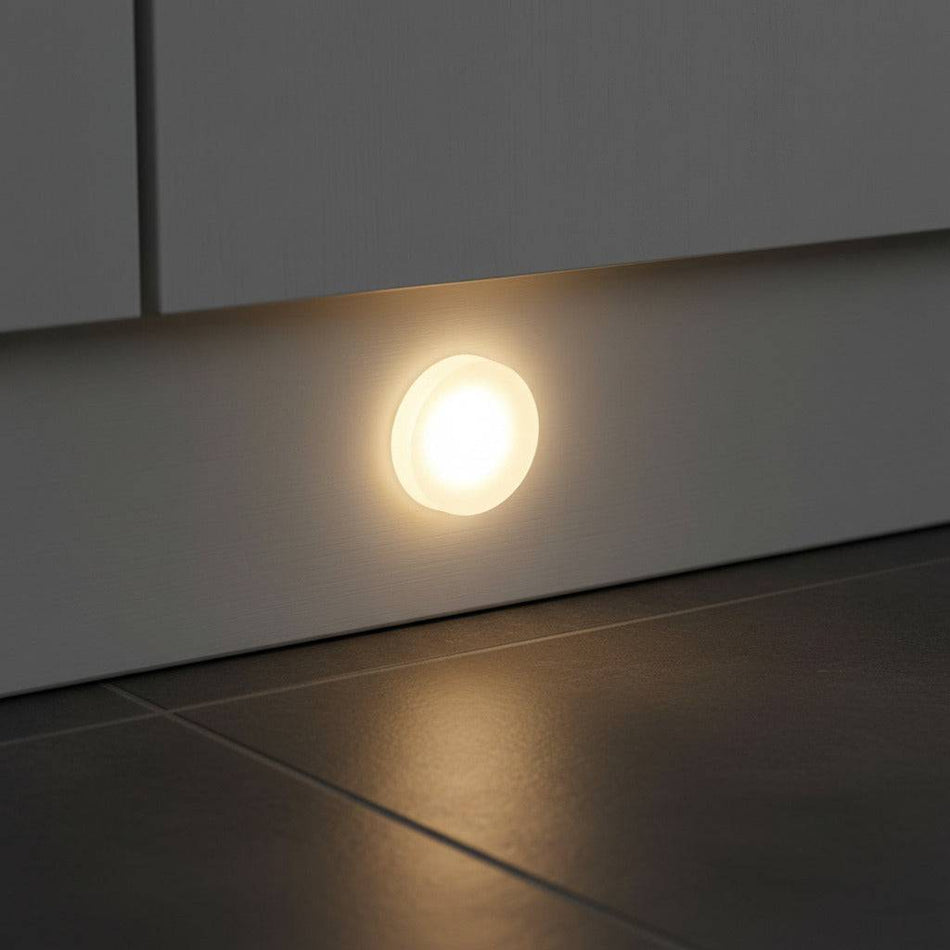 under plinth light shown recessed into a white kitchen kickboard 