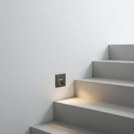black motion sensor light for stairs fitted in the wall alongside a staircase