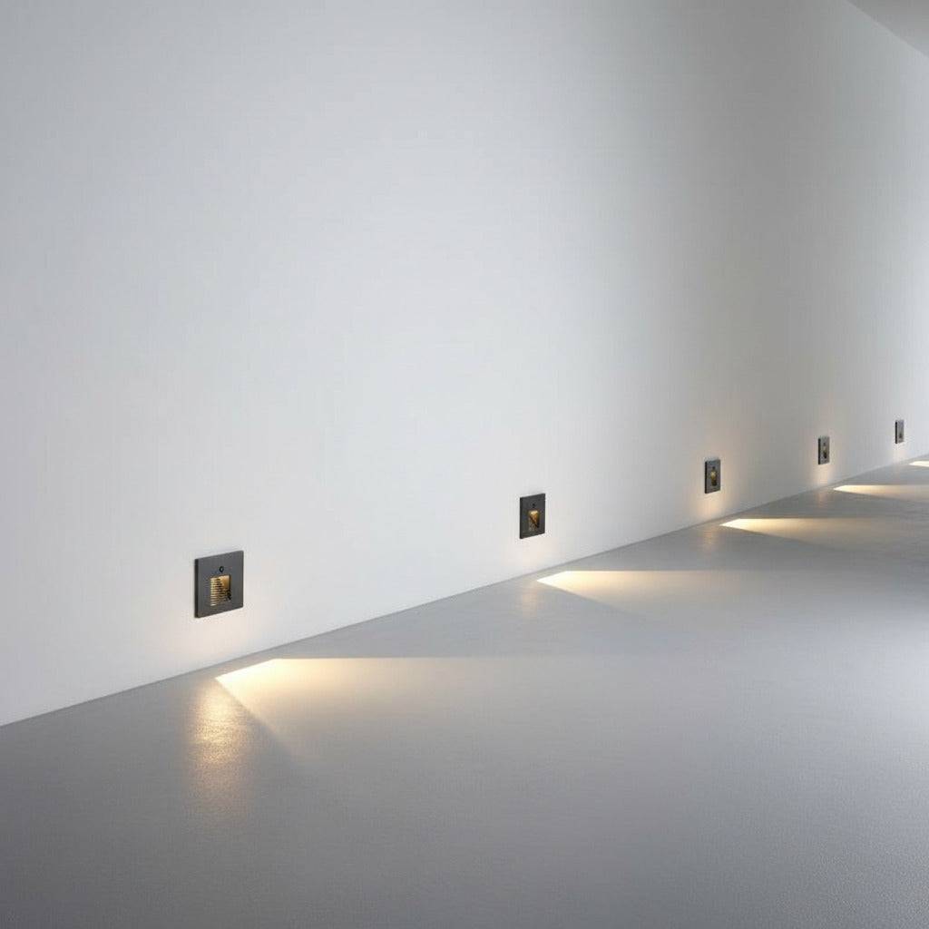 black motion sensor light for stairs installed at low level along a wall 