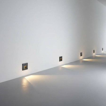 black motion sensor light for stairs installed at low level along a wall 