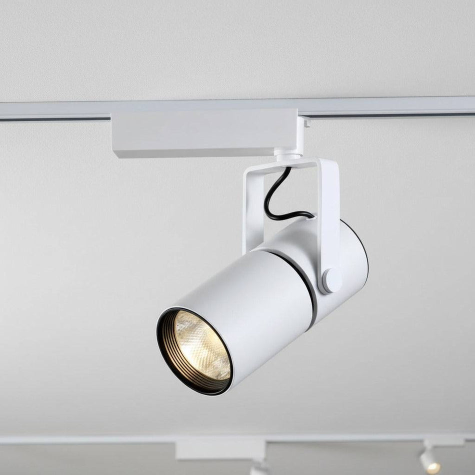 white commercial track lighting fitting mounted on a white ceiling