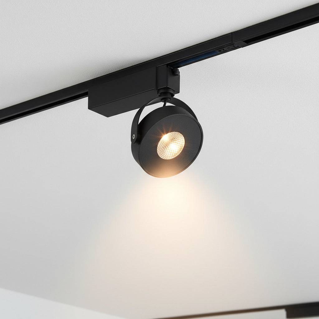 black track lighting fitting mounted on white ceiling in a shop 